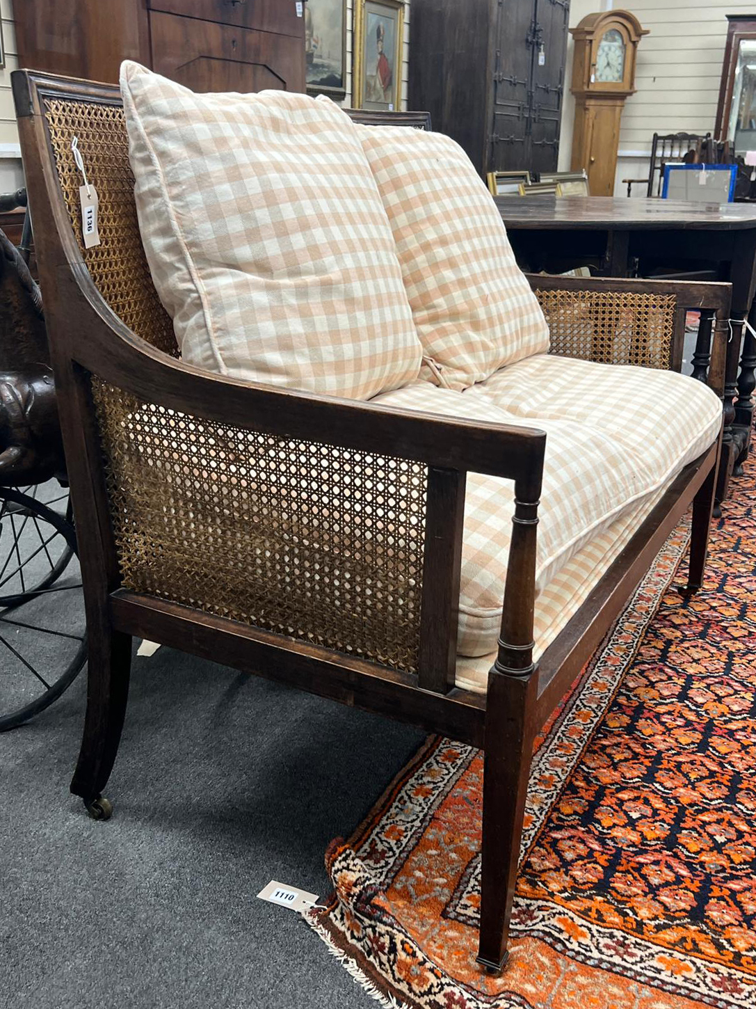 An Edwardian George III style mahogany Bergere settee with loose cushion seat and back, width 120cm, depth 62cm, height 95cm